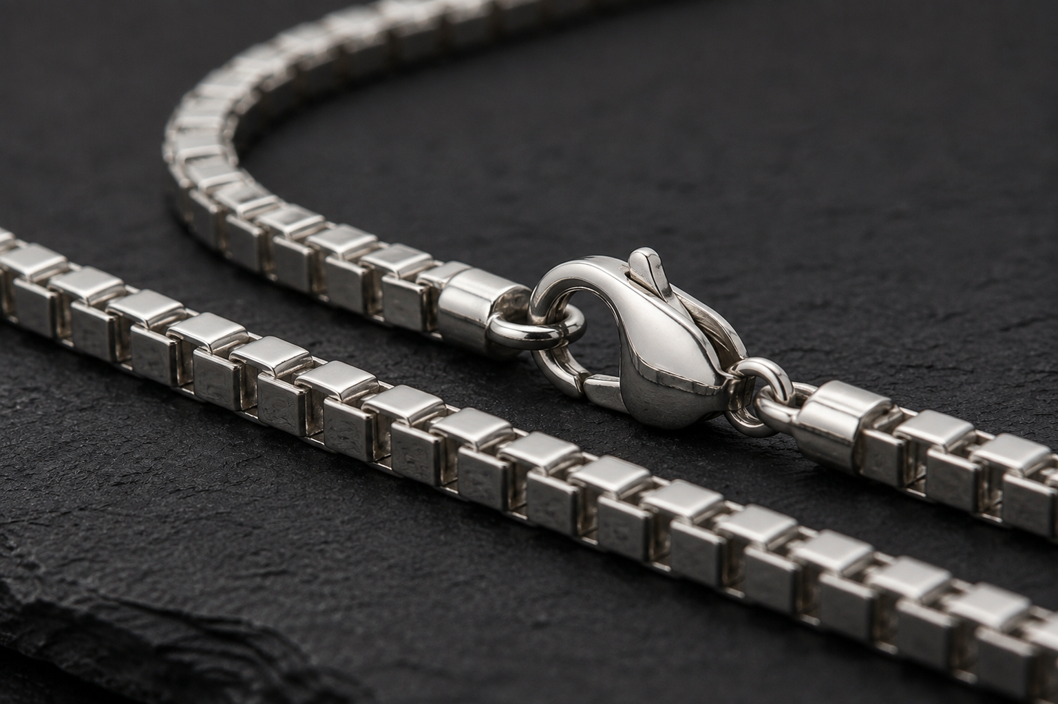 Close-up of lobster clasp on 925 sterling silver box chain necklace