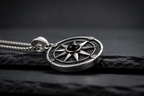 Close-up of the Praise Jewels Compass Pendant showing natural black onyx and compass detailing