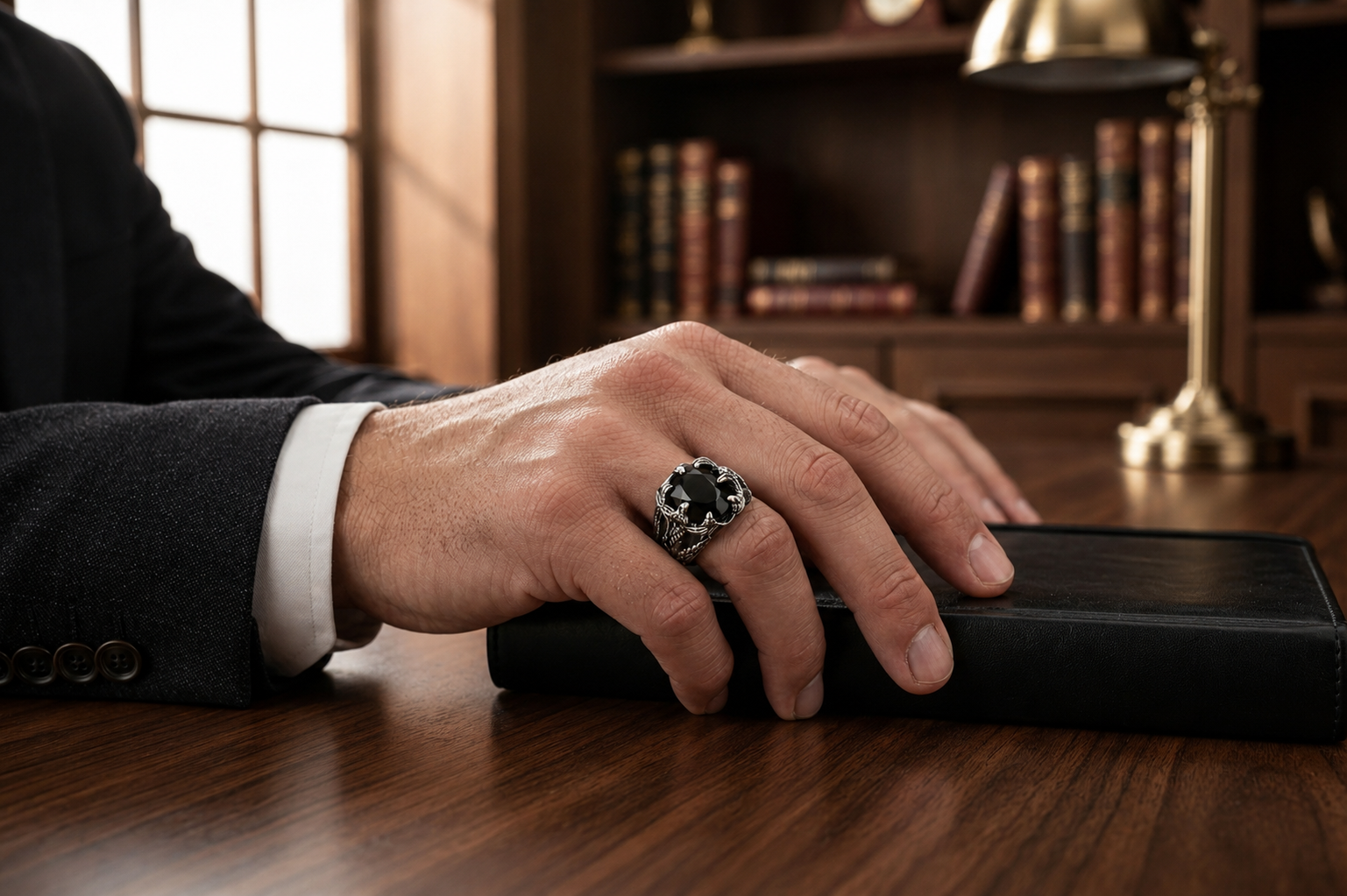 Praise Jewels Dragon Claw Ring worn by a man in tailored clothing
