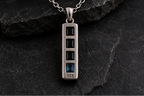 Front view of Praise Jewels Monolith Bar Pendant with black onyx and blue topaz