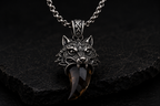 Close-up detail of Praise Jewels Wolf Tooth Pendant and smoky quartz gemstone
