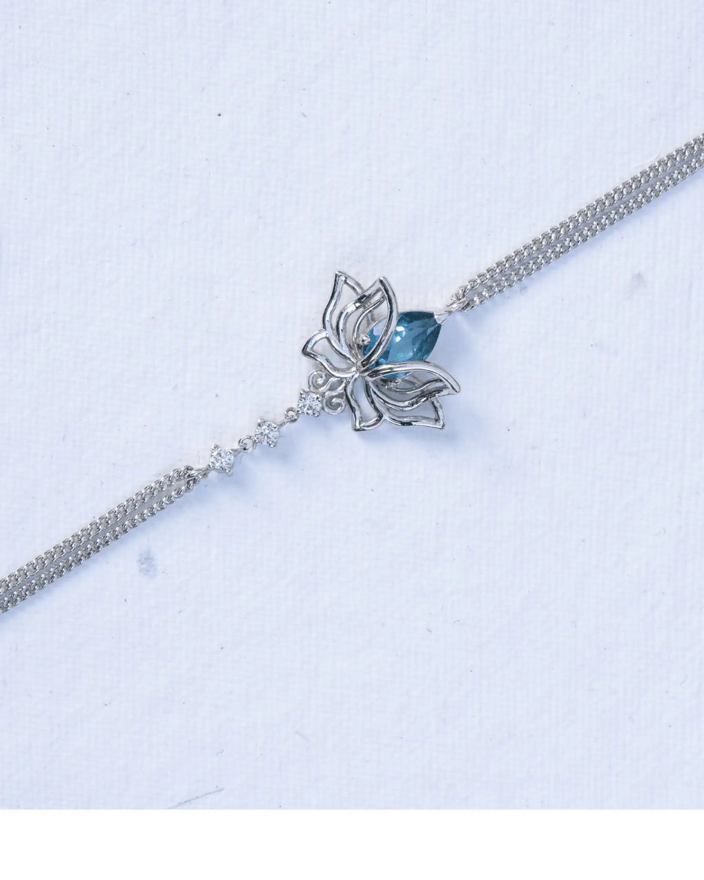 Blue Topaz Lotus Bracelet in 925 sterling silver, front view worn on the wrist