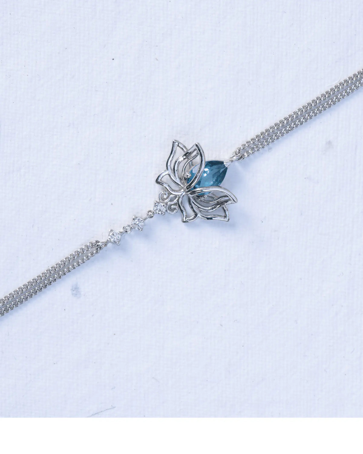 Blue Topaz Lotus Bracelet in 925 sterling silver, front view worn on the wrist