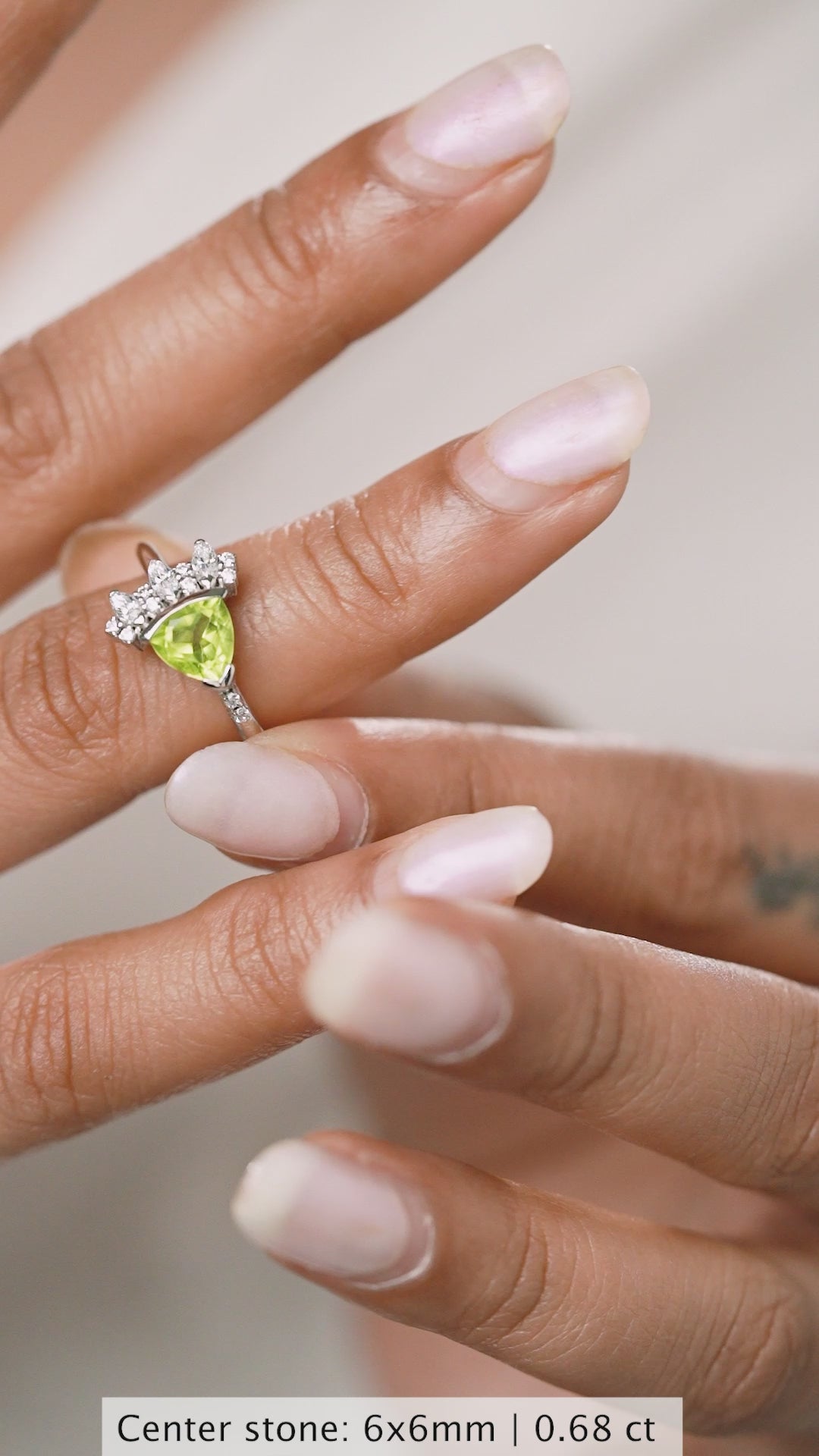 Peridot Bloom Ring in 925 sterling silver, video turning on the hand to catch the light across the olive-green peridot